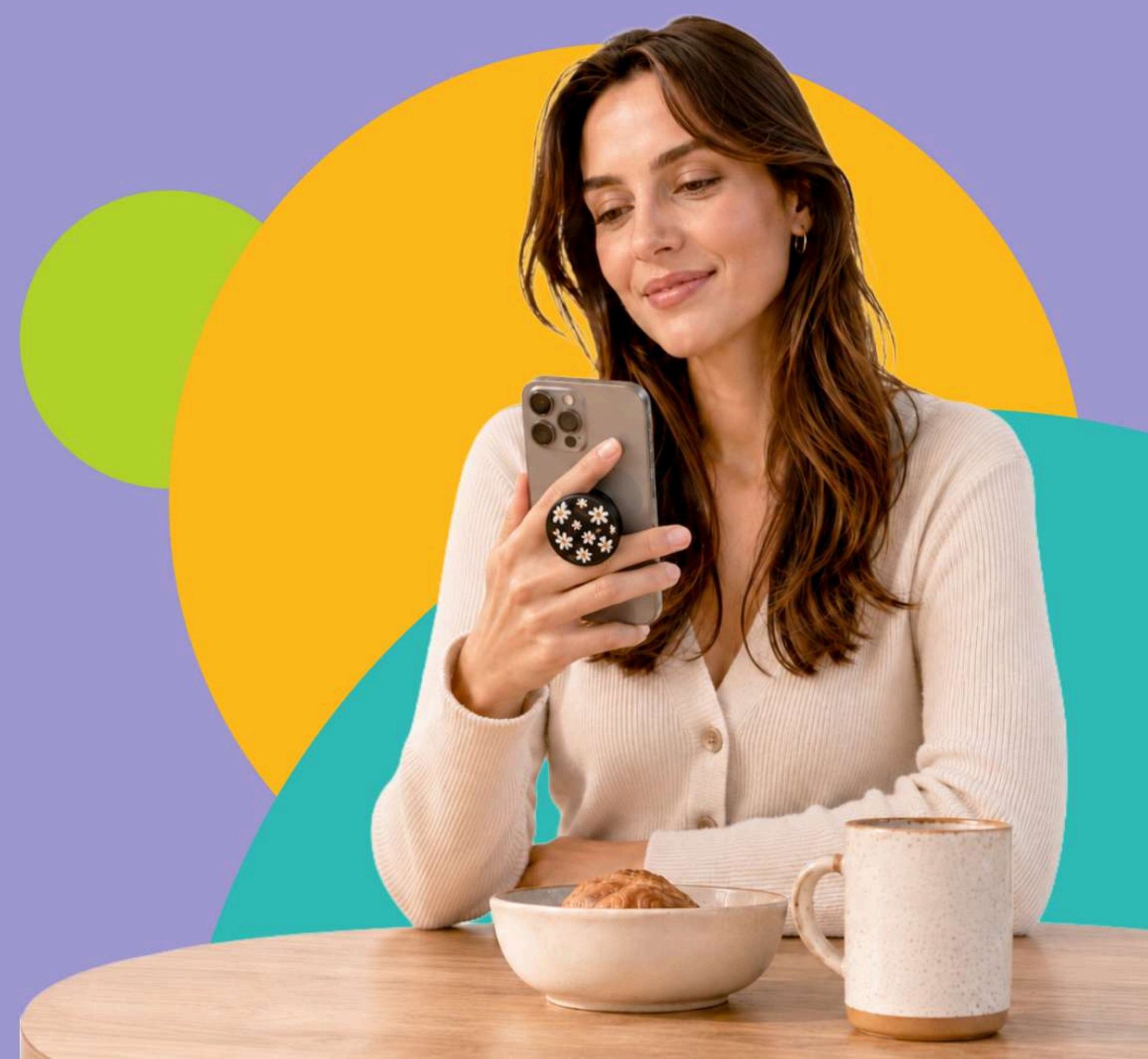 Woman using a phone with a Grabbit floral grip attached
